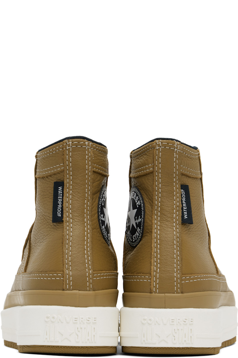 High-top waterproof grained leather sneakers in tan.

· Lace-up closure
· Logo patch at padded tongue and inner side
· Padded collar
· Logo flag at heel counter
· Cushioned OrthoLite® footbed
· Water-resistant 3M Thinsulate™ mesh lining
· Logo embossed at foam rubber midsole
· Treaded rubber sole
· Contrast stitching in white

Supplier color: Toadstool tan/Toadstool tan/Vintage white