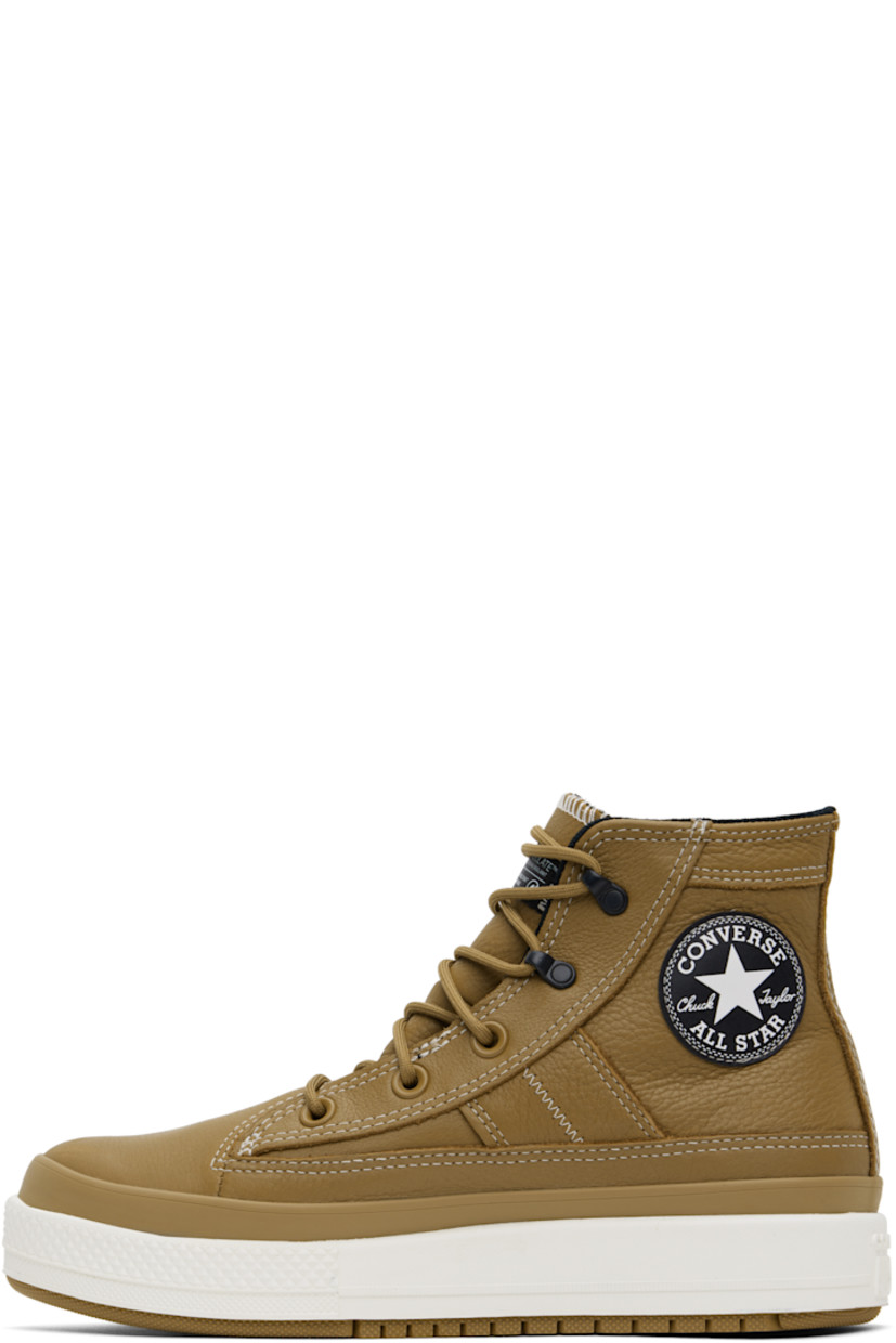 High-top waterproof grained leather sneakers in tan.

· Lace-up closure
· Logo patch at padded tongue and inner side
· Padded collar
· Logo flag at heel counter
· Cushioned OrthoLite® footbed
· Water-resistant 3M Thinsulate™ mesh lining
· Logo embossed at foam rubber midsole
· Treaded rubber sole
· Contrast stitching in white

Supplier color: Toadstool tan/Toadstool tan/Vintage white