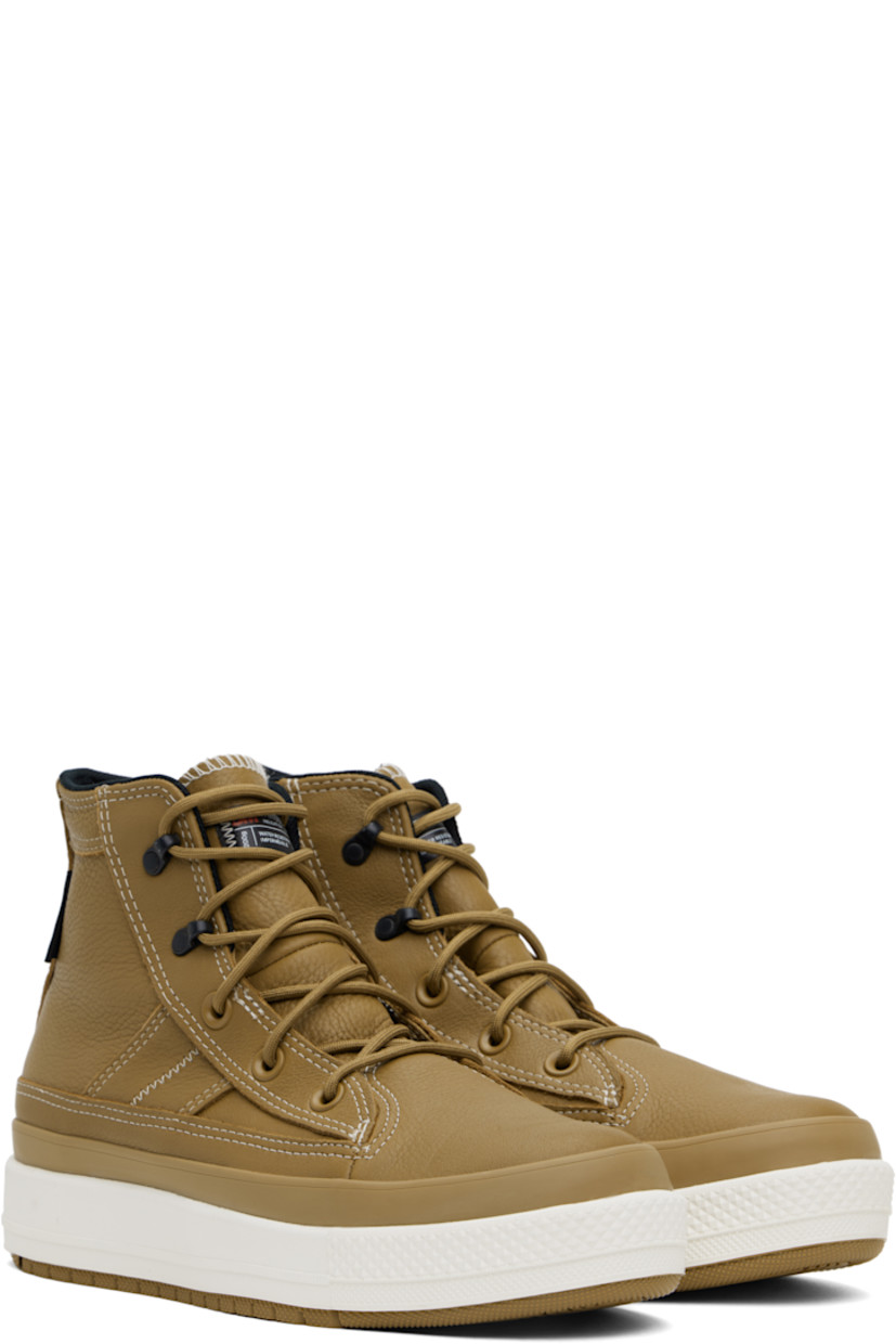 High-top waterproof grained leather sneakers in tan.

· Lace-up closure
· Logo patch at padded tongue and inner side
· Padded collar
· Logo flag at heel counter
· Cushioned OrthoLite® footbed
· Water-resistant 3M Thinsulate™ mesh lining
· Logo embossed at foam rubber midsole
· Treaded rubber sole
· Contrast stitching in white

Supplier color: Toadstool tan/Toadstool tan/Vintage white