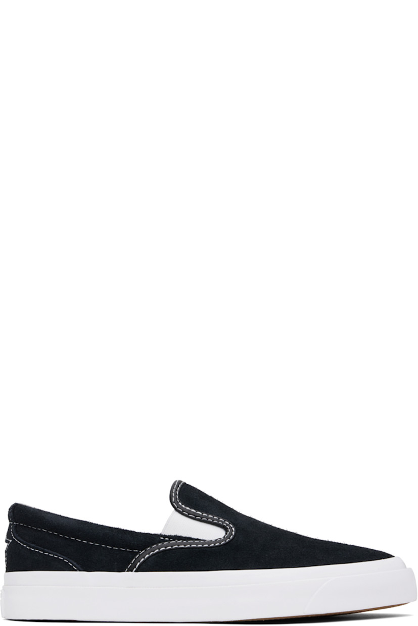 Low-top suede slip-on sneakers in black.

· Elasticized gussets at vamp
· Padded collar
· Logo cutout at heel counter
· Cushioned CX foam insole
· Suede lining
· Rubber logo patch at heel
· Textured rubber midsole
· CONS treaded rubber sole
· Contrast stitching in white

Supplier color: Black/White/White