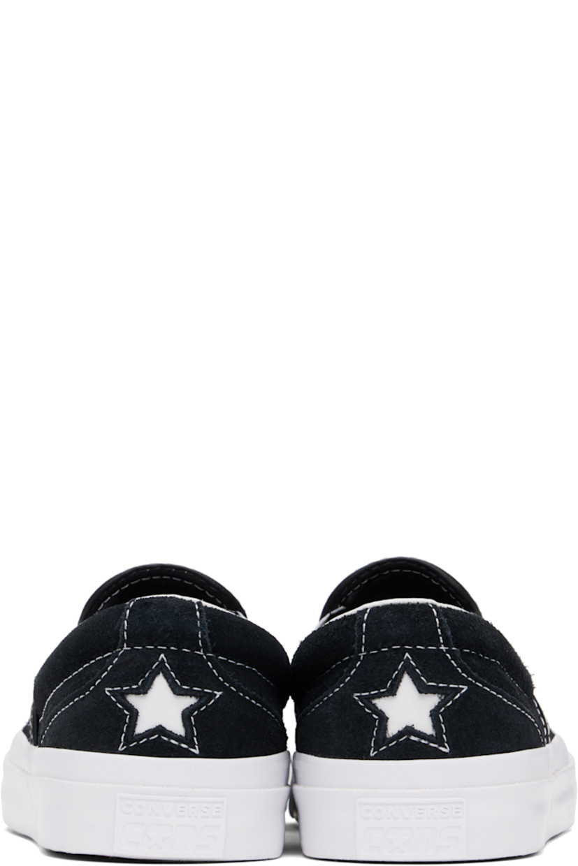 Low-top suede slip-on sneakers in black.

· Elasticized gussets at vamp
· Padded collar
· Logo cutout at heel counter
· Cushioned CX foam insole
· Suede lining
· Rubber logo patch at heel
· Textured rubber midsole
· CONS treaded rubber sole
· Contrast stitching in white

Supplier color: Black/White/White