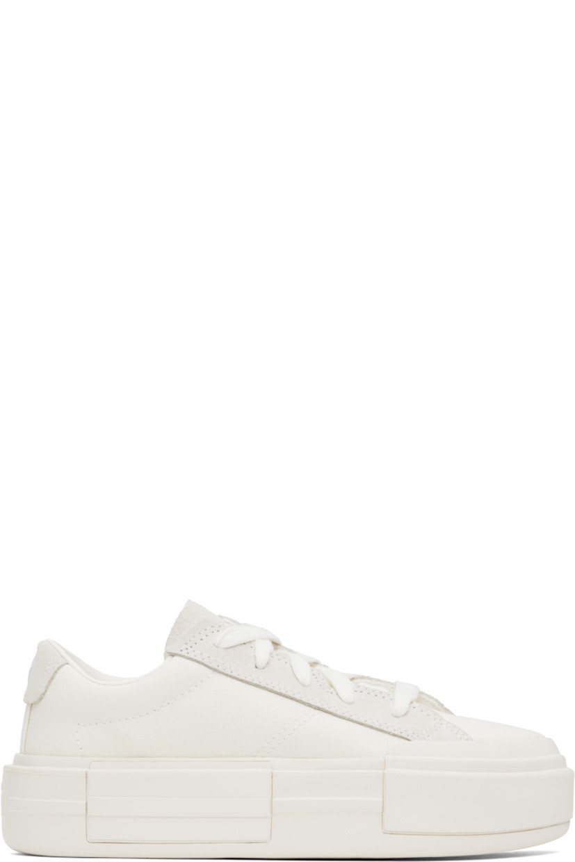 Low-top canvas sneakers in off-white.

· Lace-up closure
· Logo embossed at tongue and heel
· Padded tongue and collar
· Cushioned OrthoLite® footbed
· Mesh lining
· Logo embossed at platform midsole
· Treaded rubber sole
· Platform: H2"

Supplier color: Egret/White/Egret
