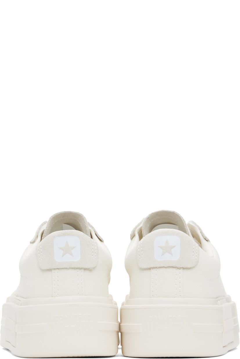 Low-top canvas sneakers in off-white.

· Lace-up closure
· Logo embossed at tongue and heel
· Padded tongue and collar
· Cushioned OrthoLite® footbed
· Mesh lining
· Logo embossed at platform midsole
· Treaded rubber sole
· Platform: H2"

Supplier color: Egret/White/Egret