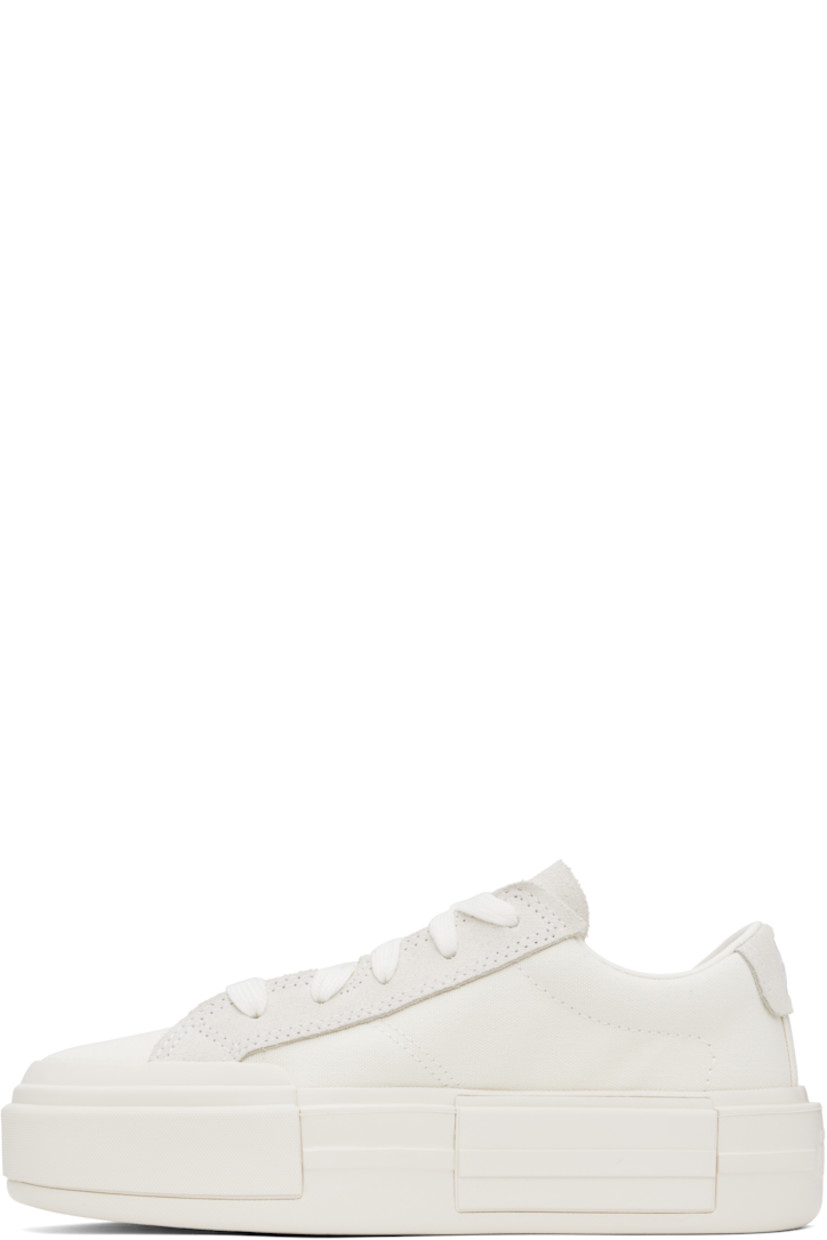 Low-top canvas sneakers in off-white.

· Lace-up closure
· Logo embossed at tongue and heel
· Padded tongue and collar
· Cushioned OrthoLite® footbed
· Mesh lining
· Logo embossed at platform midsole
· Treaded rubber sole
· Platform: H2"

Supplier color: Egret/White/Egret