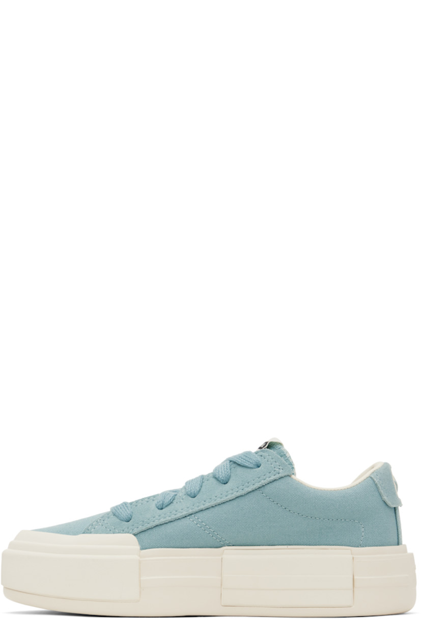 Low-top lightweight canvas and suede sneakers in blue.

· Lace-up closure
· Logo patch at padded tongue
· Padded collar
· Logo stamp at heel tab
· Cushioned OrthoLite® footbed
· Mesh lining
· Logo embossed at rubber platform midsole
· Treaded rubber sole
· Platform: H1.75"

Supplier color: Vernal pool/Egret/Gold