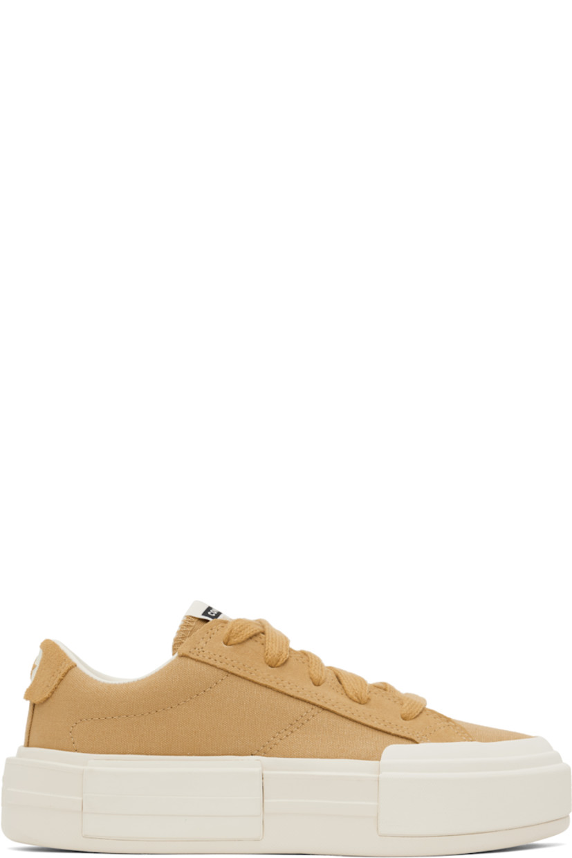 Low-top lightweight canvas and suede sneakers in tan.

· Lace-up closure
· Logo patch at padded tongue
· Padded collar
· Logo stamp at heel tab
· Cushioned OrthoLite® footbed
· Mesh lining
· Logo embossed at rubber platform midsole
· Treaded rubber sole
· Platform: H1.75"

Supplier color: Sandy shore/Egret/Sandy shore
