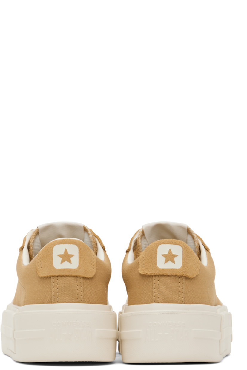 Low-top lightweight canvas and suede sneakers in tan.

· Lace-up closure
· Logo patch at padded tongue
· Padded collar
· Logo stamp at heel tab
· Cushioned OrthoLite® footbed
· Mesh lining
· Logo embossed at rubber platform midsole
· Treaded rubber sole
· Platform: H1.75"

Supplier color: Sandy shore/Egret/Sandy shore