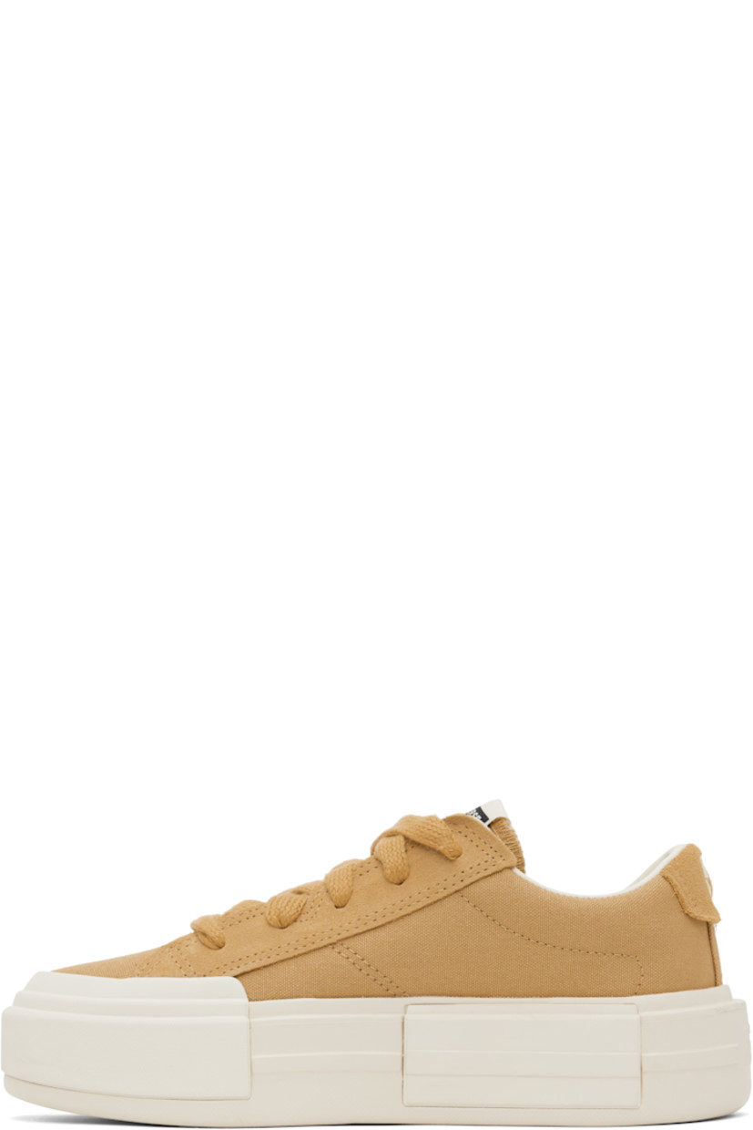Low-top lightweight canvas and suede sneakers in tan.

· Lace-up closure
· Logo patch at padded tongue
· Padded collar
· Logo stamp at heel tab
· Cushioned OrthoLite® footbed
· Mesh lining
· Logo embossed at rubber platform midsole
· Treaded rubber sole
· Platform: H1.75"

Supplier color: Sandy shore/Egret/Sandy shore