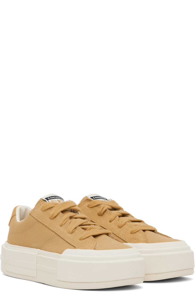 Low-top lightweight canvas and suede sneakers in tan.

· Lace-up closure
· Logo patch at padded tongue
· Padded collar
· Logo stamp at heel tab
· Cushioned OrthoLite® footbed
· Mesh lining
· Logo embossed at rubber platform midsole
· Treaded rubber sole
· Platform: H1.75"

Supplier color: Sandy shore/Egret/Sandy shore
