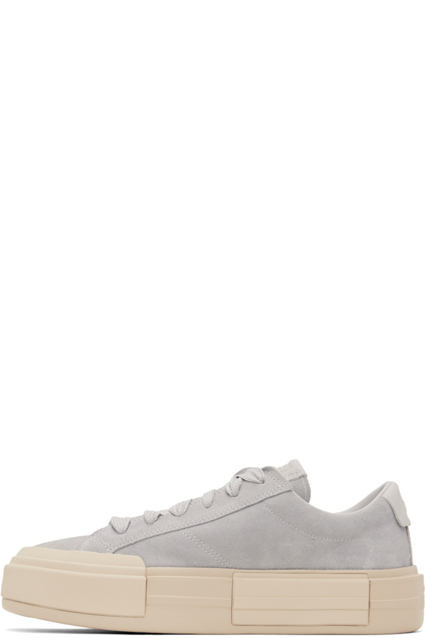 Low-top lightweight suede sneakers in gray.

· Lace-up closure
· Logo embossed at padded tongue and heel tab
· Padded collar
· Cushioned OrthoLite® footbed
· Mesh lining
· Logo embossed at rubber platform midsole
· Treaded rubber sole
· Platform: H1.75"

Supplier color: Grey area/Natural ivory