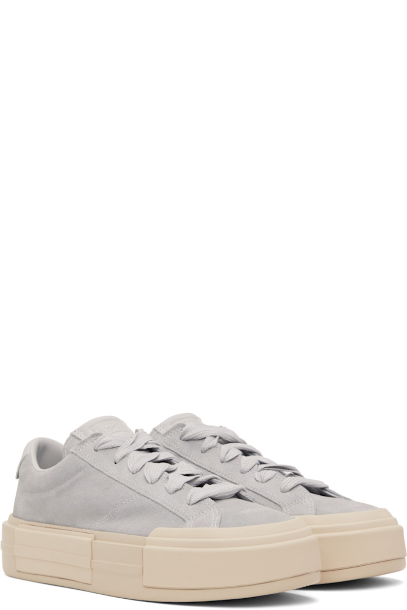 Low-top lightweight suede sneakers in gray.

· Lace-up closure
· Logo embossed at padded tongue and heel tab
· Padded collar
· Cushioned OrthoLite® footbed
· Mesh lining
· Logo embossed at rubber platform midsole
· Treaded rubber sole
· Platform: H1.75"

Supplier color: Grey area/Natural ivory