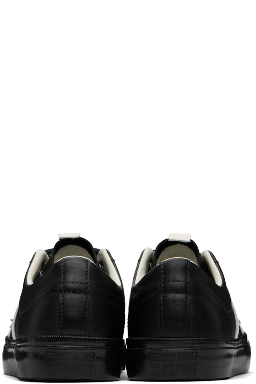 Low-top buffed leather sneakers in black.

· Lace-up closure
· Pull-tab at tongue
· Concealed elasticized gusset at tongue
· Padded collar
· Logo and stripe appliqués at sides
· Perforated detailing at sides
· Cushioned CX foam insole
· Canvas and mesh lining
· Rubberized logo patch at heel
· Treaded rubber sole
· Includes alternate laces in black

Part of the Converse x Bobby Dekeyzer collaboration.

Supplier color: Black/Egret/Black