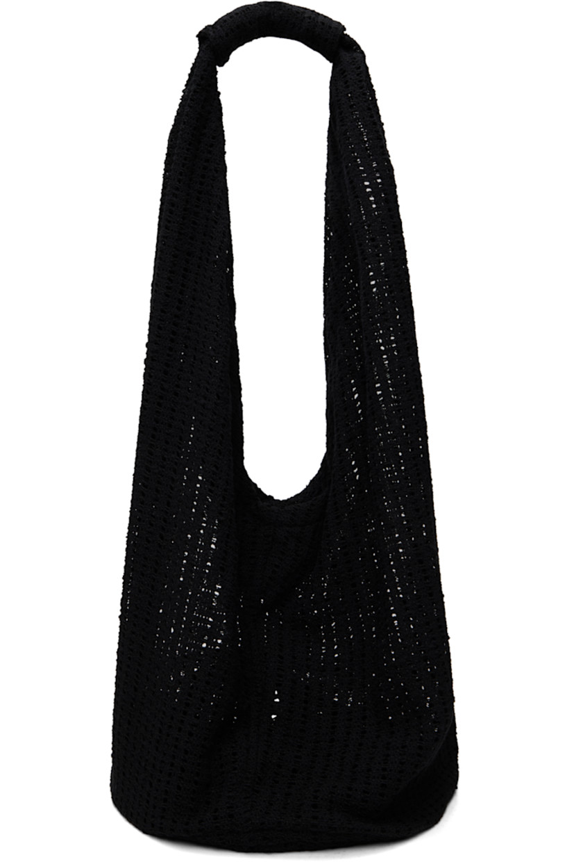 Crocheted tote in black.

· Integrated shoulder strap
· Open throat
· Unlined
· H13" x W14.5" x D10"
· Total height: H26"

Supplier color: Black crochet