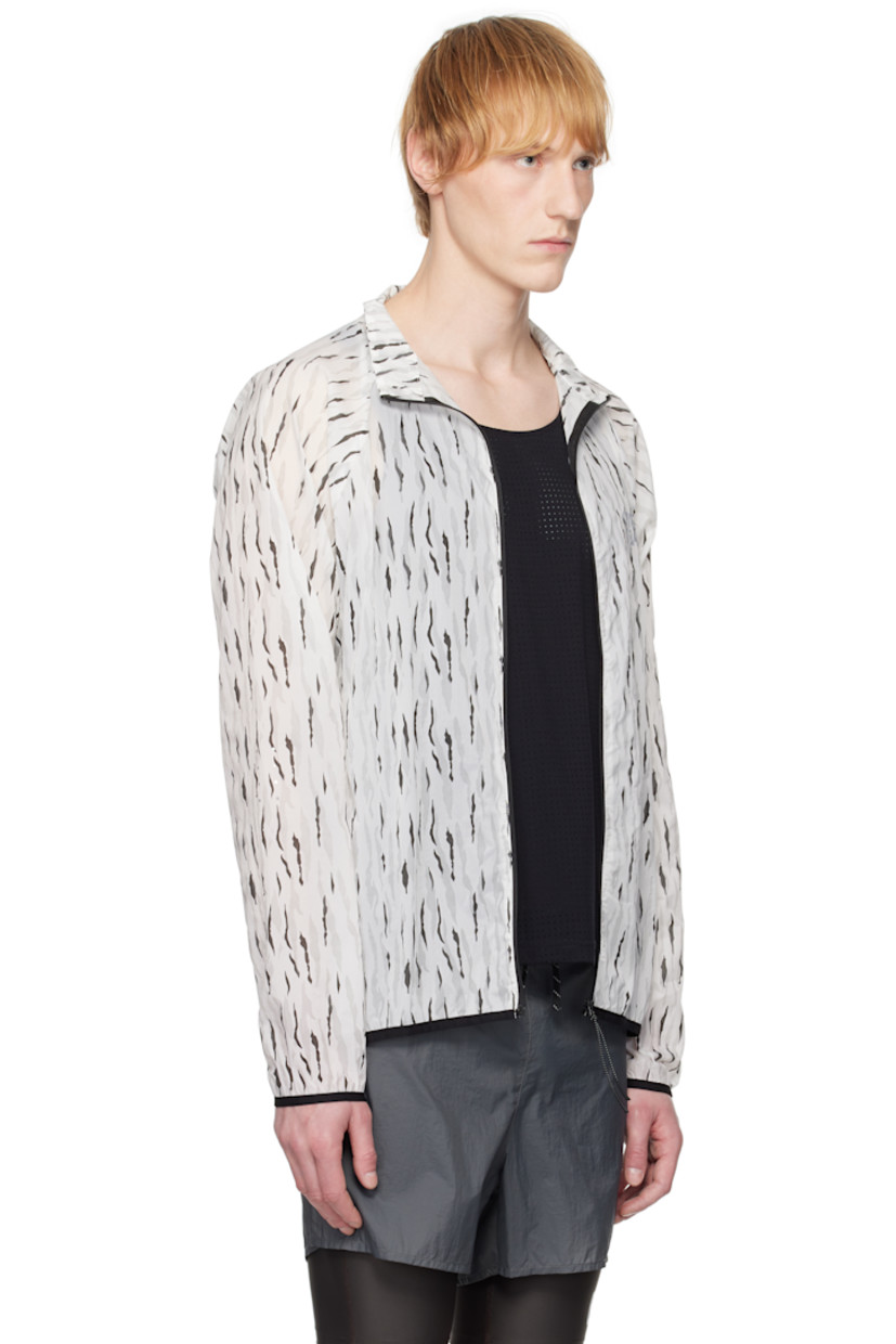 Semi-sheer nylon taffeta jacket. Graphic pattern printed throughout. 

· Stand collar 
· Zip closure 
· Logo bonded at chest
· Zip pocket at front
· Elasticized hem and cuffs
· Mesh patch pockets at side
· Unlined

Supplier color: Eric