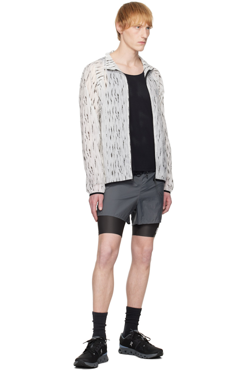 Semi-sheer nylon taffeta jacket. Graphic pattern printed throughout. 

· Stand collar 
· Zip closure 
· Logo bonded at chest
· Zip pocket at front
· Elasticized hem and cuffs
· Mesh patch pockets at side
· Unlined

Supplier color: Eric