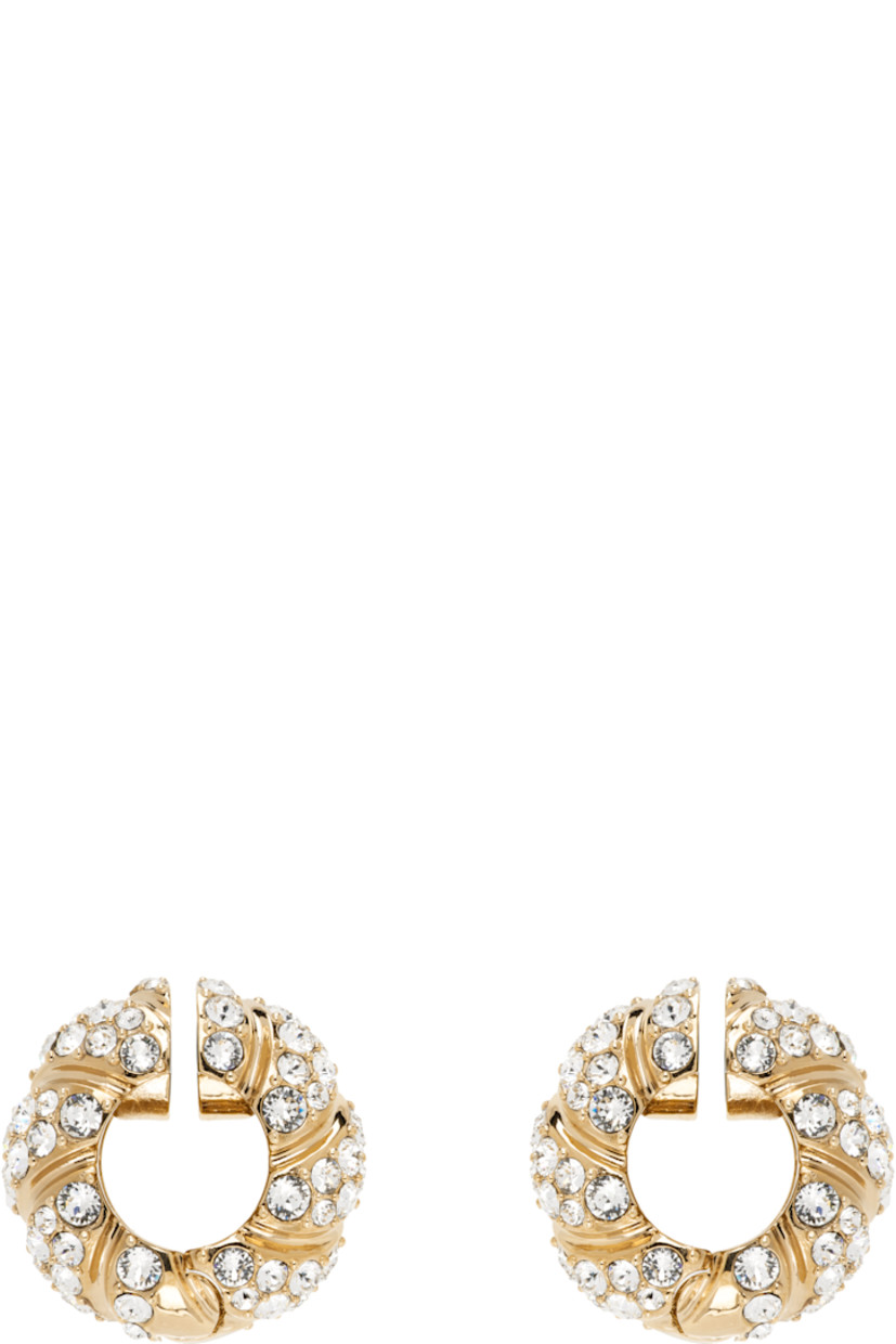 Pair of hoop earrings in gold tone. 

· Twisted detailing and crystals throughout 
· Magnetic hinged fastening 
· D0.75"

Supplier color: Gold/Crystal
