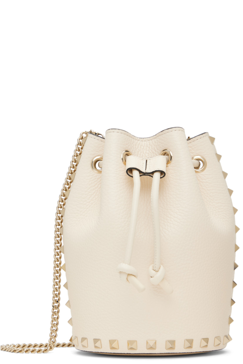 Grained leather shoulder bag in off-white.

· Signature pyramid studs throughout
· Detachable curb chain crossbody strap
· Drawstring closure
· Buffed leather lining
· H7.5" x W5" x D4"

Supplier color: Light ivory