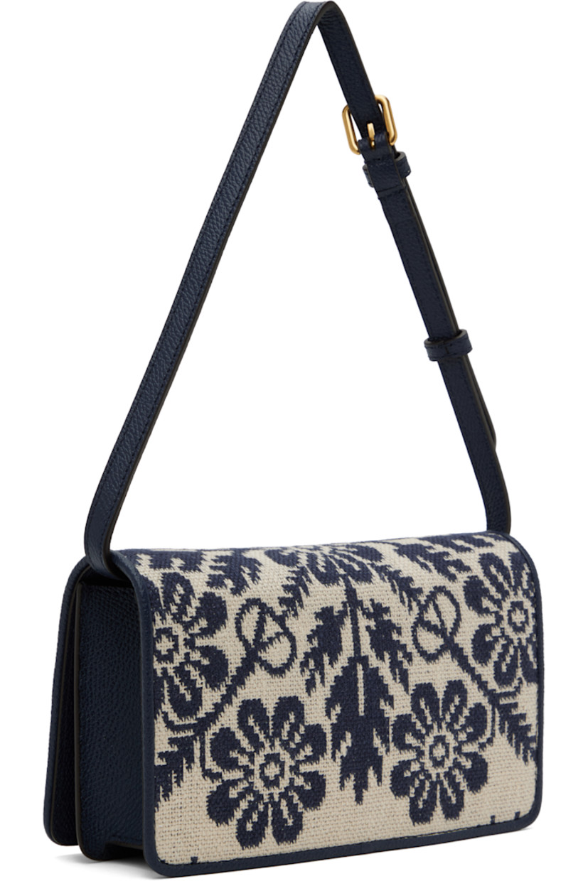 Canvas and grained leather shoulder bag in beige and navy.

· Jacquard floral pattern throughout
· Adjustable and detachable shoulder strap
· Logo hardware at face
· Magnetic flap closure
· Zip pocket at interior 
· Three card slots
· Buffed nappa leather lining 
· Gold-tone hardware
· H5" x W8" x D2"

Supplier color: Avorio blue/Dark