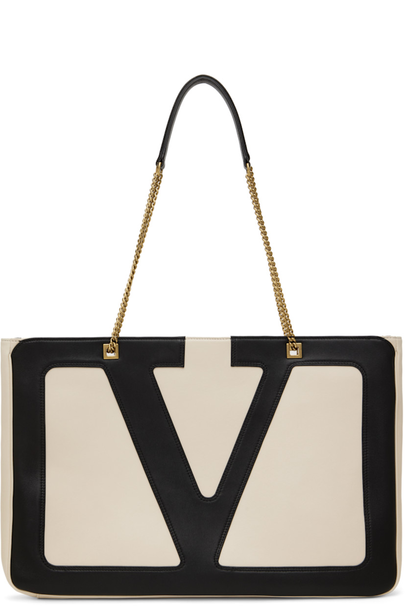 Grained nappa lambskin shoulder bag in off-white and black.

· Sliding curb chain shoulder straps
· Logo appliqué at face
· Zip pocket at back face
· Zip closure
· Grained nappa leather lining
· H12" x W17.5" x D1.5"

Supplier color: Butter/Black