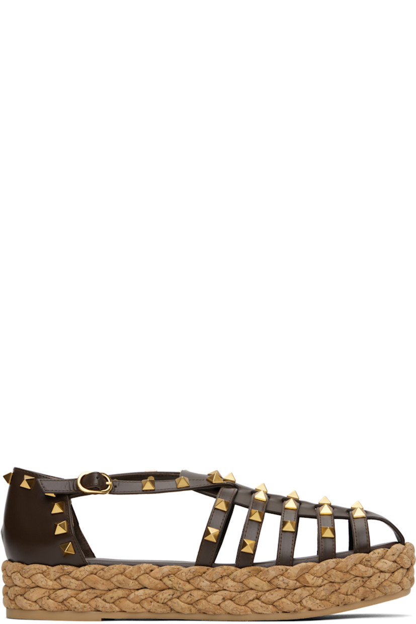 Buffed leather sandals in brown.

· Signature pyramid studs throughout
· Straps at vamp
· Pin-buckle strap at collar
· Buffed leather and suede lining
· Braided cork platform midsole
· Treaded rubber sole
· Antiqued brass-tone hardware
· Platform: H1.5"

Supplier color: Bark brown/Natural