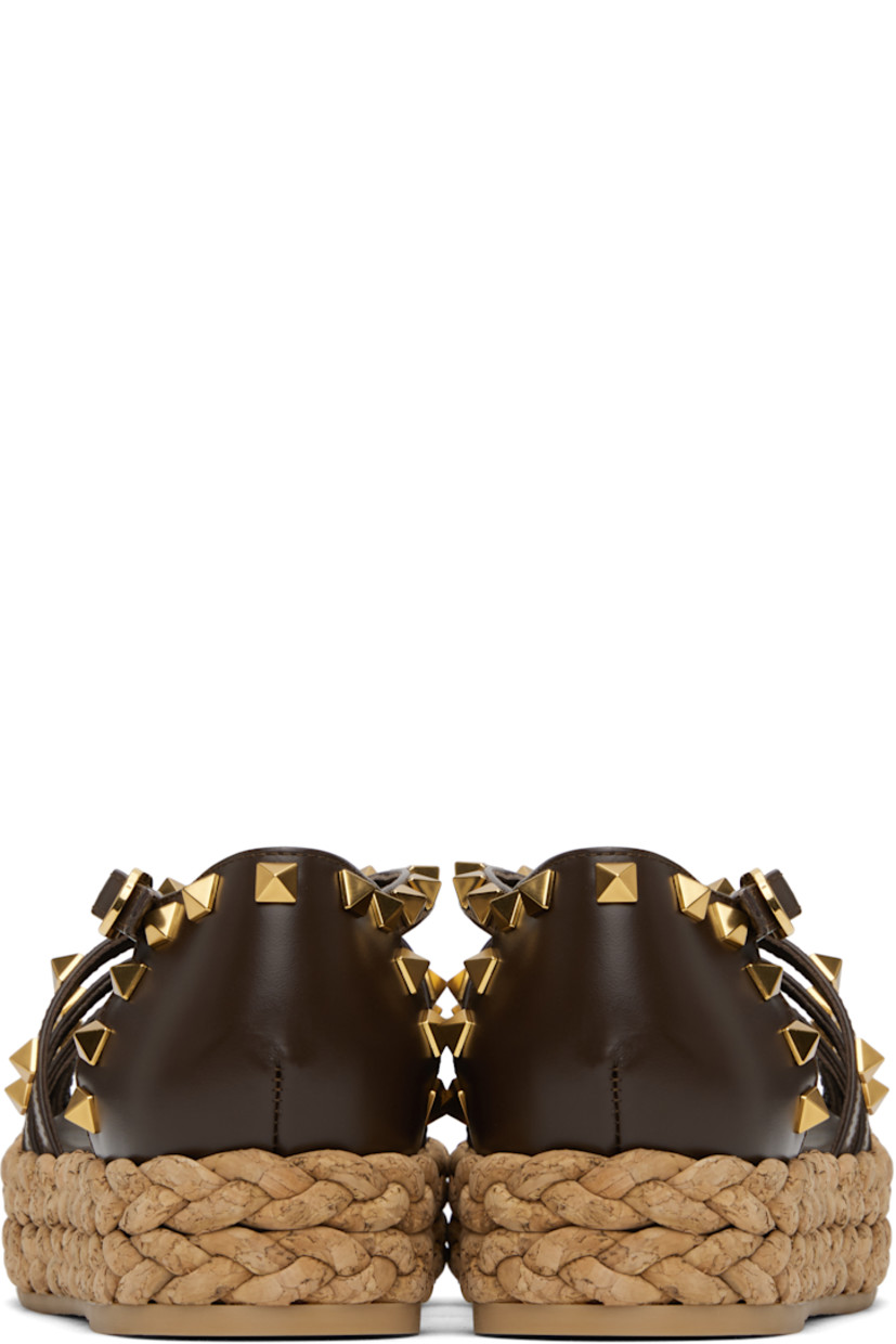 Buffed leather sandals in brown.

· Signature pyramid studs throughout
· Straps at vamp
· Pin-buckle strap at collar
· Buffed leather and suede lining
· Braided cork platform midsole
· Treaded rubber sole
· Antiqued brass-tone hardware
· Platform: H1.5"

Supplier color: Bark brown/Natural