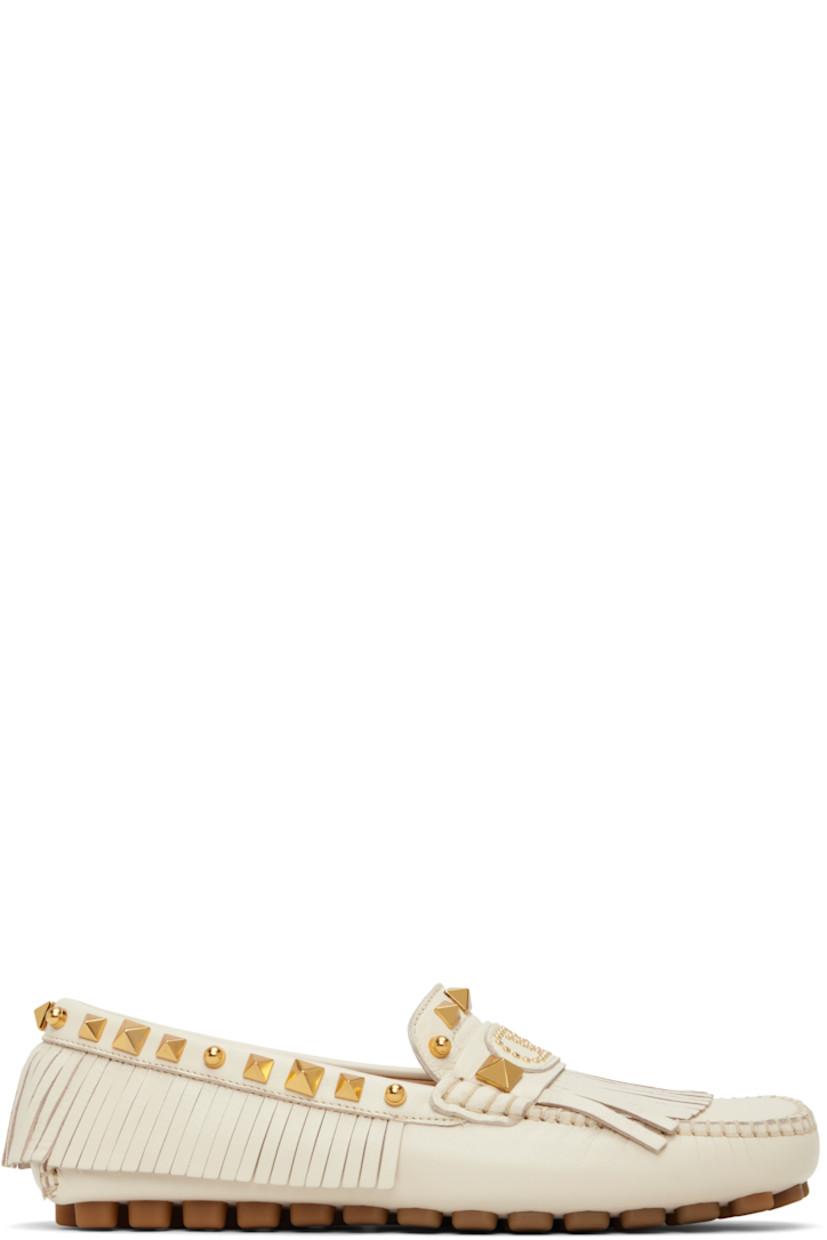 Grained leather loafers in off-white.

· Fringed detailing and pyramid studs throughout
· Blanket stitching at square moc toe
· Logo patch at vamp
· Buffed leather lining
· Treaded rubber sole

Supplier color: Ivory