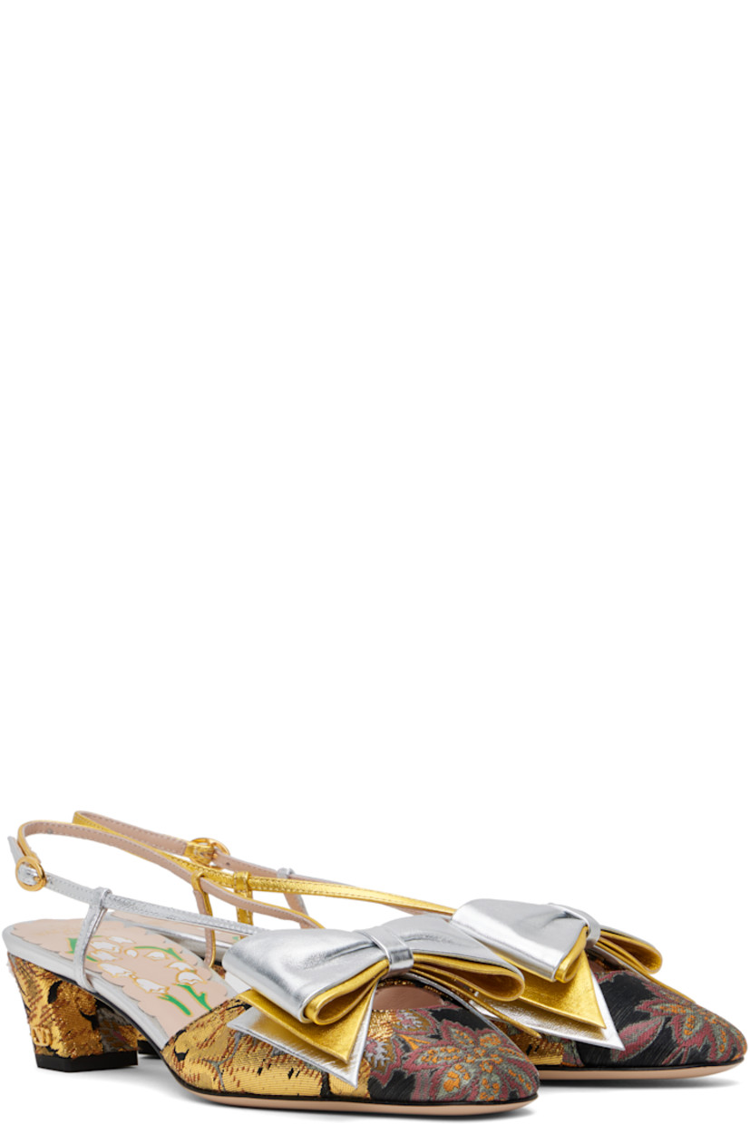 Grained leather and brocade heels in silver tone, gold tone, and black.

· Jacquard pattern throughout
· Bow accent at vamp
· Pin-buckle slingback strap
· Covered block heel with rubber injection
· Logo hardware at heel
· Leather sole
· Heel: H1.75"

Supplier color: Jacquard multi