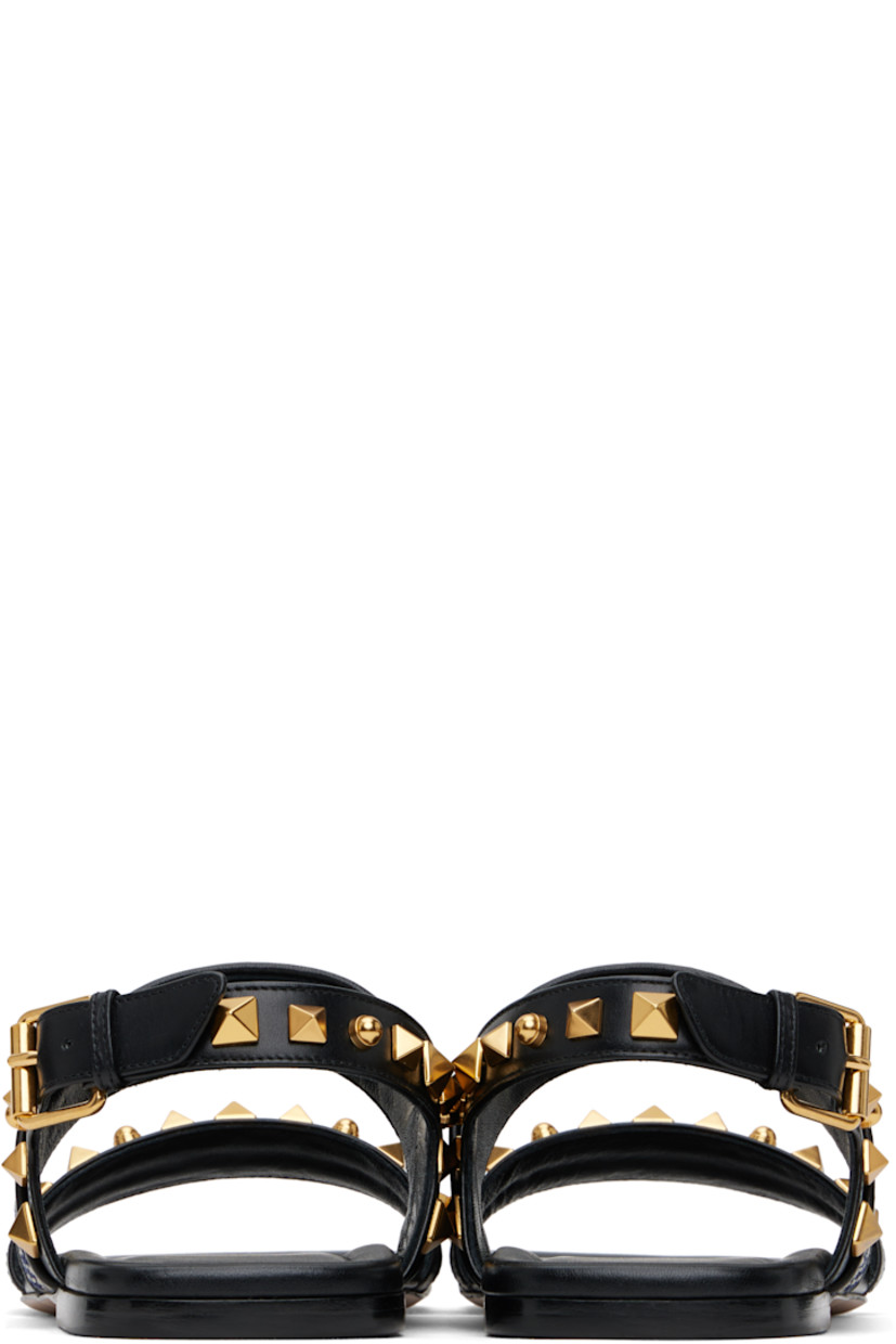 Buffed leather sandals in black.

· Signature pyramid studs throughout
· Open square toe
· Graphic-embroidered strap at vamp
· Pin-buckle slingback strap
· Buffed leather lining
· Logo printed at padded footbed
· Polished leather sole with rubber injection
· Antiqued brass-tone hardware

Supplier color: Black