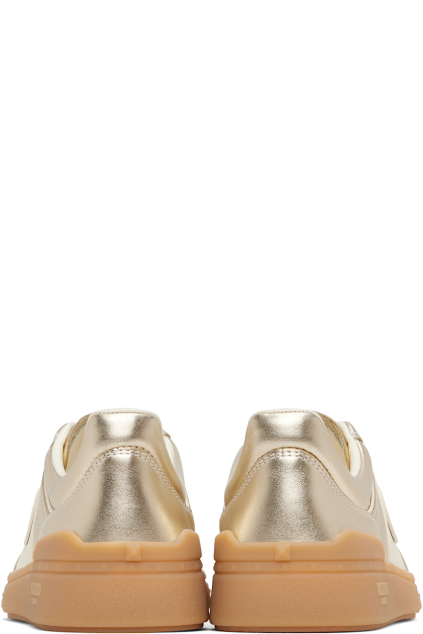 Low-top grained nappa calfskin sneakers in gold tone.

· Lace-up closure
· Inset logo patch at padded tongue
· Padded collar
· Logo patch at outer side
· Buffed leather and mesh lining
· Logo and pyramid studs embossed at midsole
· Treaded rubber sole

Supplier color: Platinum
