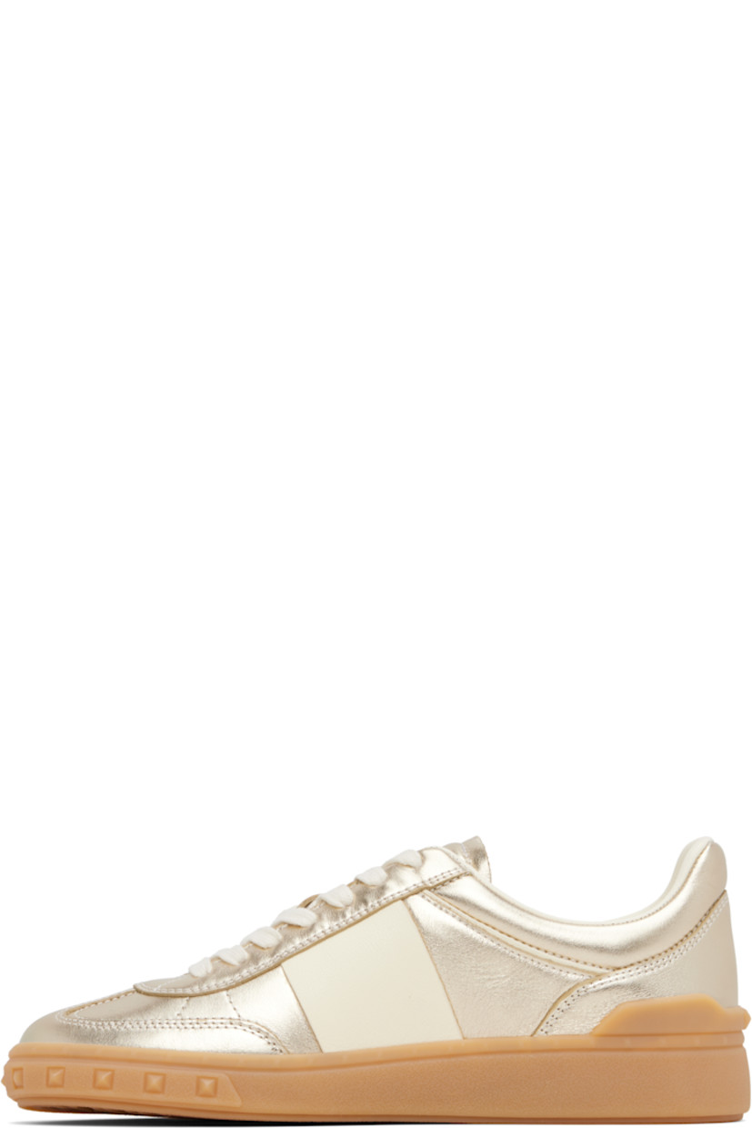 Low-top grained nappa calfskin sneakers in gold tone.

· Lace-up closure
· Inset logo patch at padded tongue
· Padded collar
· Logo patch at outer side
· Buffed leather and mesh lining
· Logo and pyramid studs embossed at midsole
· Treaded rubber sole

Supplier color: Platinum