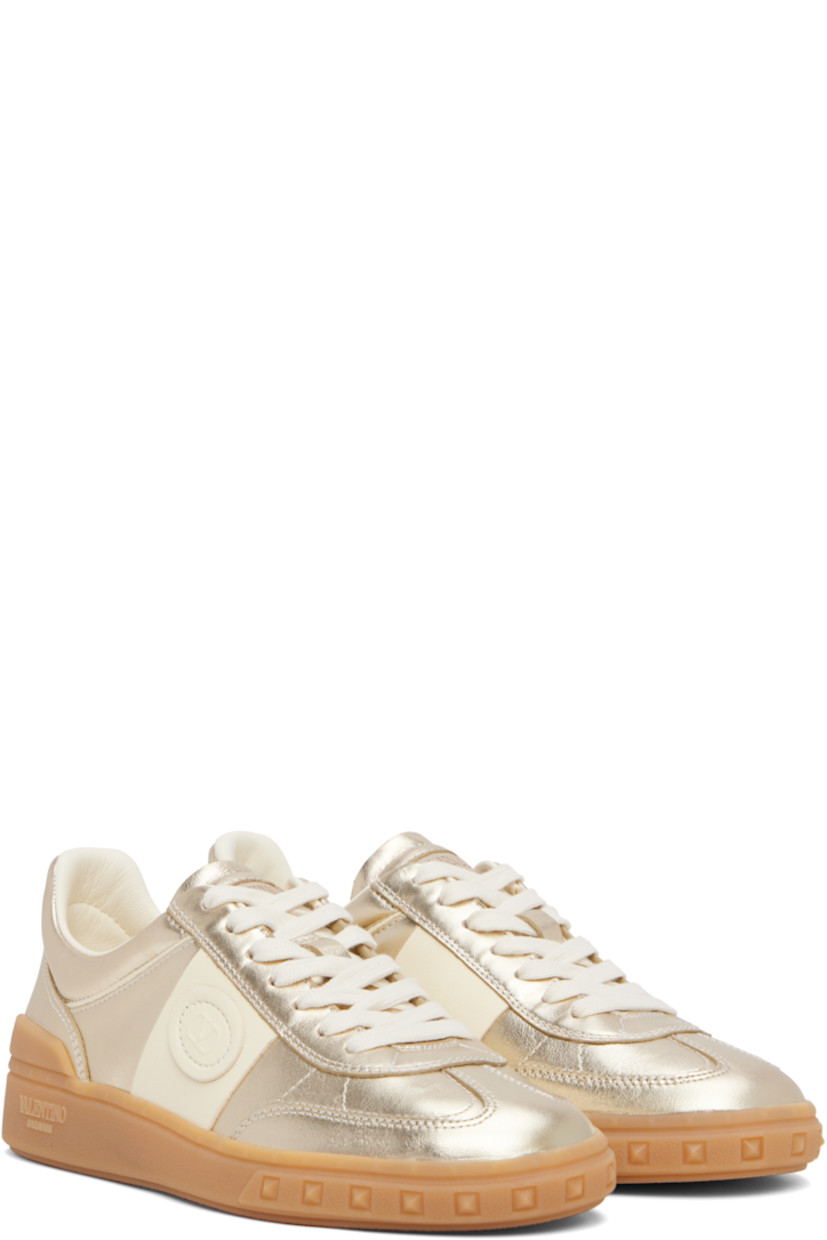 Low-top grained nappa calfskin sneakers in gold tone.

· Lace-up closure
· Inset logo patch at padded tongue
· Padded collar
· Logo patch at outer side
· Buffed leather and mesh lining
· Logo and pyramid studs embossed at midsole
· Treaded rubber sole

Supplier color: Platinum