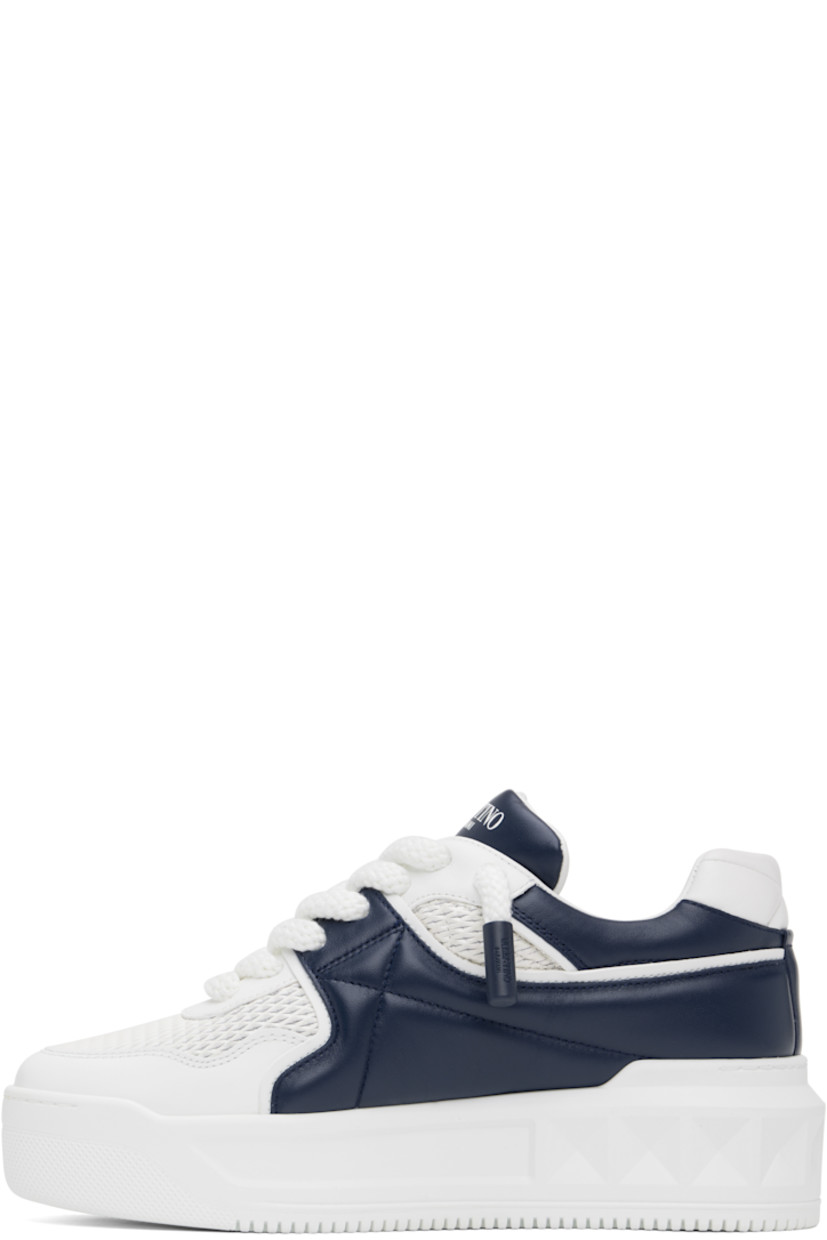 Low-top buffed calfskin sneakers in white and navy.

· Perforated detailing throughout
· Lace-up closure
· Padded tongue and collar
· Concealed elasticized gussets at tongue
· Logo printed at tongue and outer side
· Signature pyramid stud at outer side
· Quilted heel tab
· Buffed leather lining
· Logo-embossed treaded rubber platform sole
· Platform: H1.75"

Supplier color: Bianco/Worker