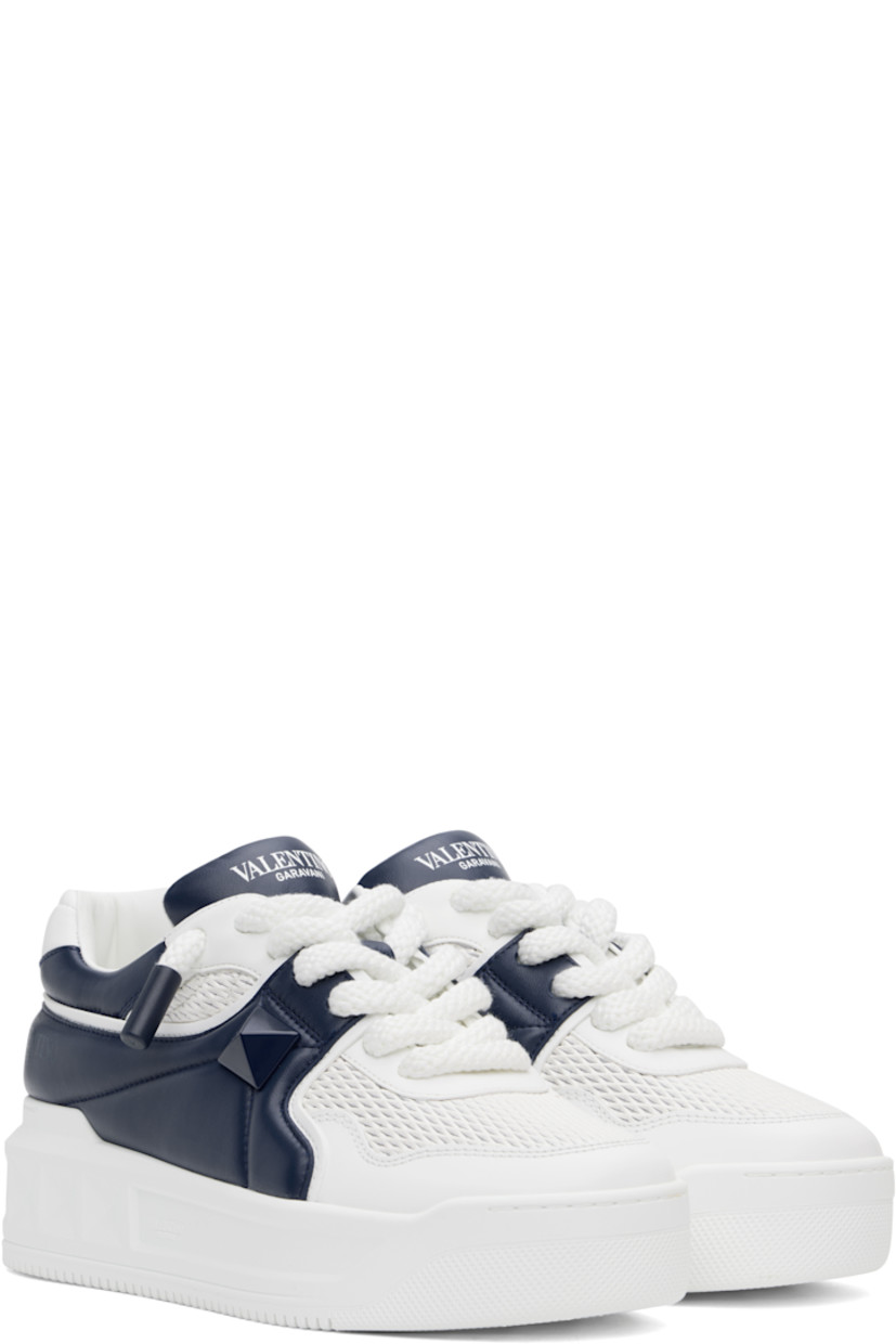 Low-top buffed calfskin sneakers in white and navy.

· Perforated detailing throughout
· Lace-up closure
· Padded tongue and collar
· Concealed elasticized gussets at tongue
· Logo printed at tongue and outer side
· Signature pyramid stud at outer side
· Quilted heel tab
· Buffed leather lining
· Logo-embossed treaded rubber platform sole
· Platform: H1.75"

Supplier color: Bianco/Worker