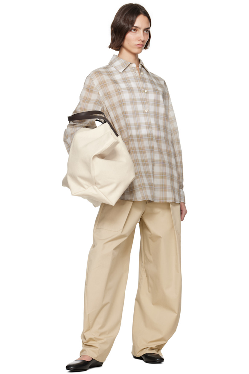 Semi-sheer polyester- and cotton-blend voile shirt. Check pattern throughout.

· Spread collar
· Button closure
· Layered panel at front
· Shirttail hem
· French cuffs
· Box pleat at back yoke

Supplier color: Beige plaid