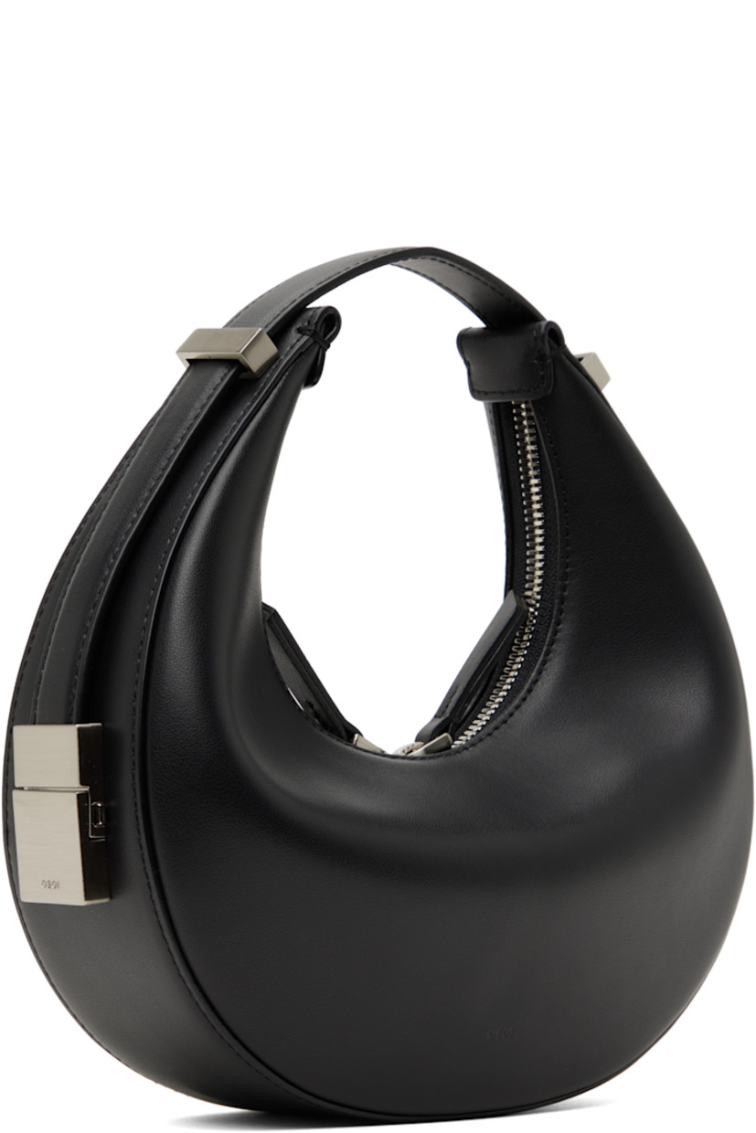 Buffed leather top handle bag in black.

· Adjustable sliding carry handle
· Logo embossed at back face
· Two-way zip closure
· Patch pocket at interior
· Microfiber lining
· Logo-engraved silver-tone hardware
· H4.5" x W8.5" x D2.25"

Supplier color: Black