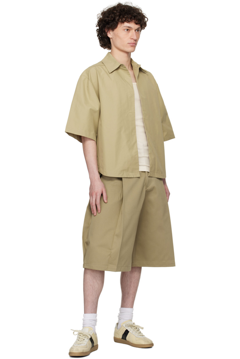 Cotton-blend ottoman shirt. 

· Spread collar
· Magnetic closure
· Seam pockets
· Shirttail hem
· Dropped shoulders
· Box pleat at back yoke

Supplier color: Biscuit