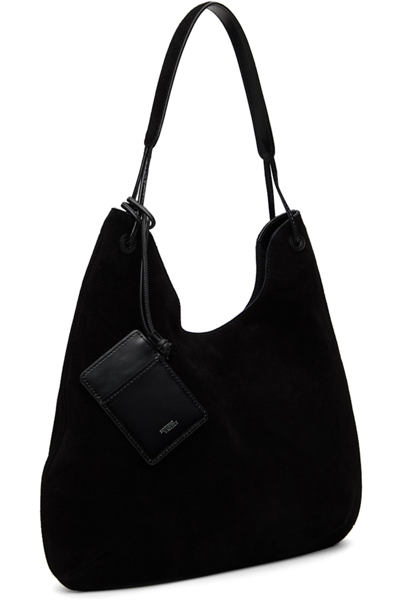 Suede shoulder bag in black.

· Fixed shoulder strap
· Detachable card holder at strap
· Magnetic closure
· Patch pocket at interior
· Cotton canvas lining
· H14" x W15.5" x D1.5"

Supplier color: Black suede