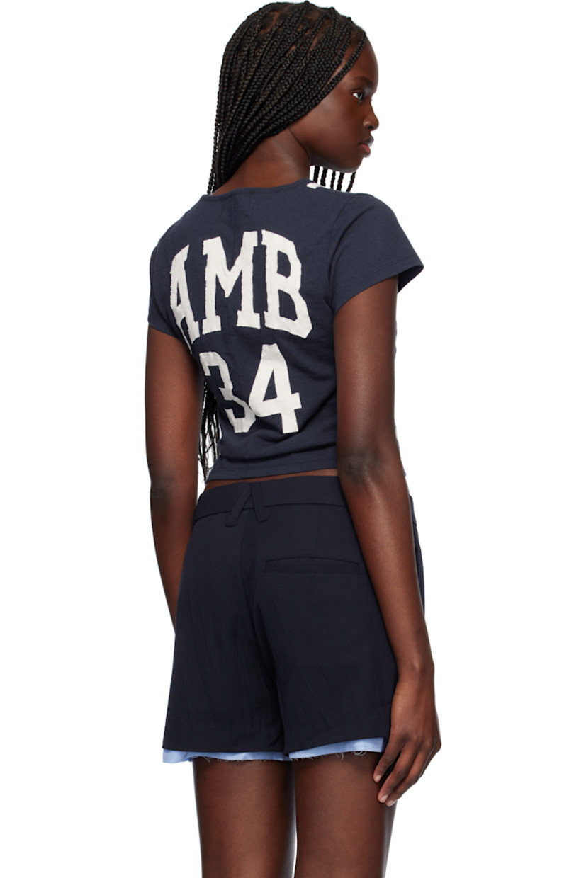 Cotton jersey T-shirt.

· Paneled construction
· Rib-knit crewneck
· Stripes at front
· Text appliqués at chest and back
· Cropped hem

Supplier color: Navy