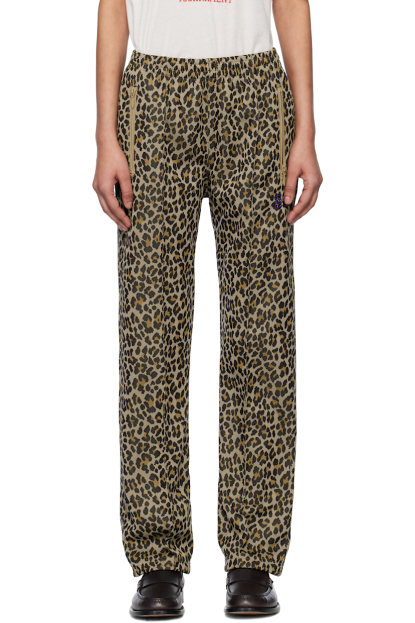 Polyester jersey track pants. Jacquard leopard pattern throughout. 

· Concealed drawstring at elasticized waistband
· Three-pocket styling
· Logo graphic embroidered at front
· Pinched seam at front legs
· Unlined 

Supplier color: Leopard