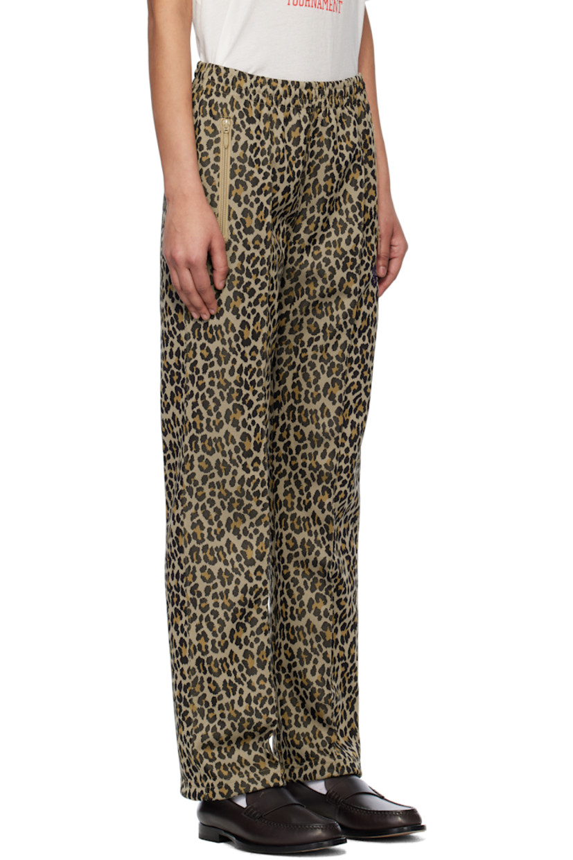Polyester jersey track pants. Jacquard leopard pattern throughout. 

· Concealed drawstring at elasticized waistband
· Three-pocket styling
· Logo graphic embroidered at front
· Pinched seam at front legs
· Unlined 

Supplier color: Leopard