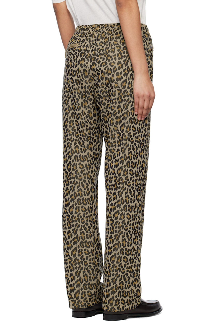 Polyester jersey track pants. Jacquard leopard pattern throughout. 

· Concealed drawstring at elasticized waistband
· Three-pocket styling
· Logo graphic embroidered at front
· Pinched seam at front legs
· Unlined 

Supplier color: Leopard