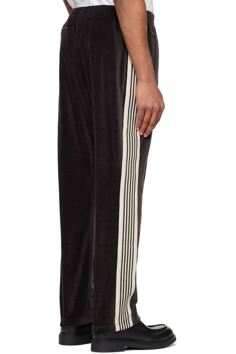 Cotton- and polyester-blend velour track pants.

· Concealed drawstring at elasticized waistband
· Three-pocket styling
· Pinched seams and embroidered logo graphic at front
· Striped knit trim at outseams

Supplier color: Charcoal