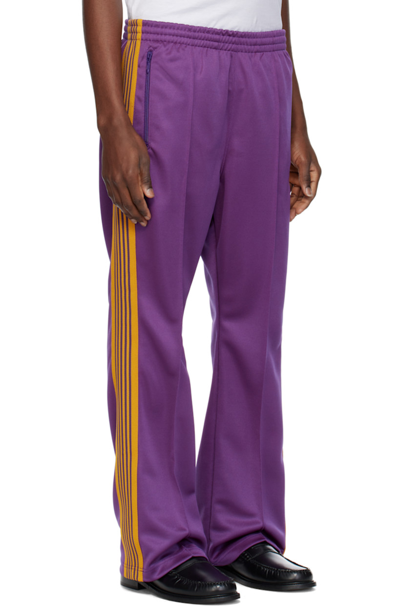 Bootcut polyester interlock jersey track pants.

· Concealed drawstring at elasticized waistband
· Three-pocket styling
· Pinched seams and embroidered logo graphic at front
· Striped knit trim at outseams

Supplier color: Purple