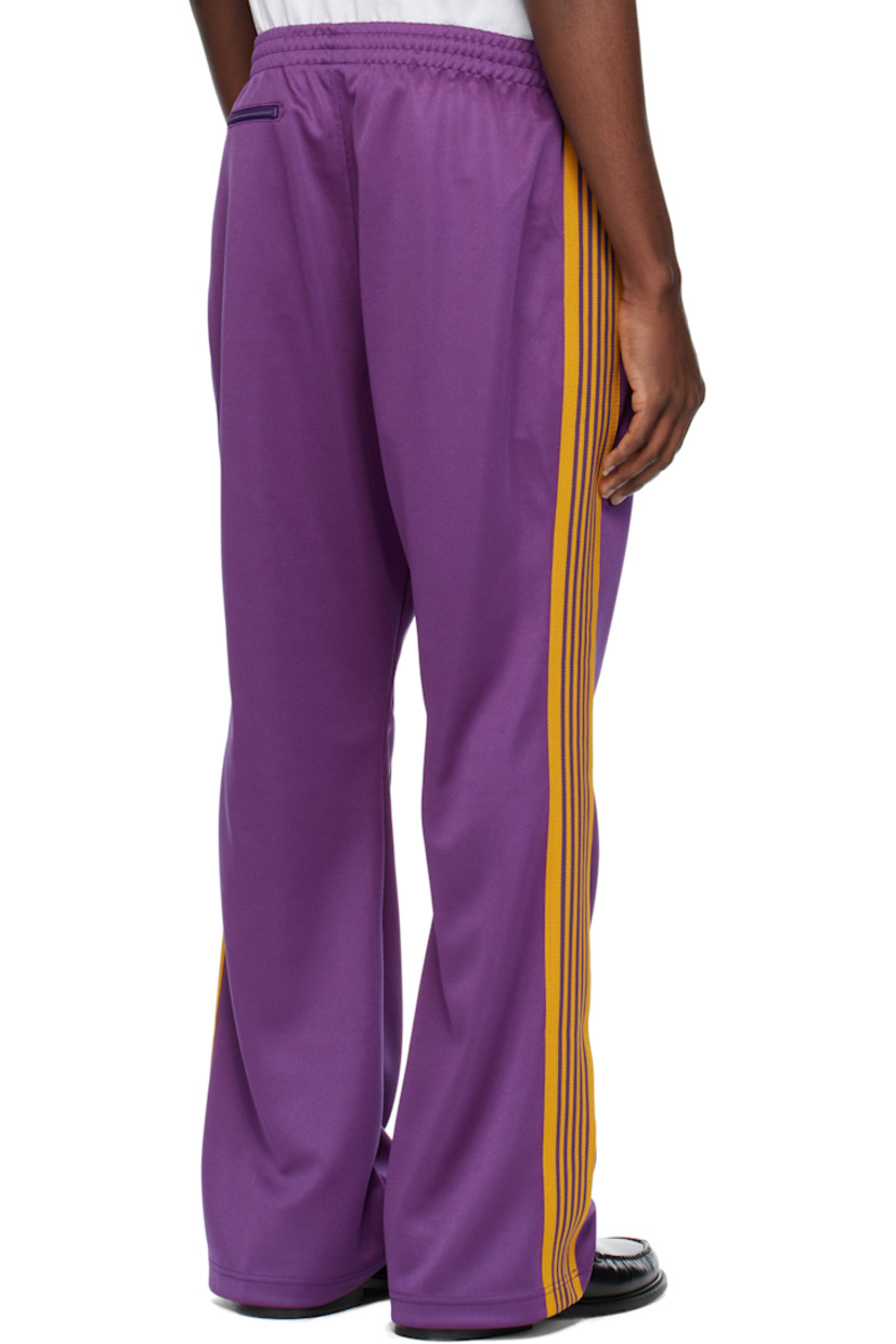 Bootcut polyester interlock jersey track pants.

· Concealed drawstring at elasticized waistband
· Three-pocket styling
· Pinched seams and embroidered logo graphic at front
· Striped knit trim at outseams

Supplier color: Purple