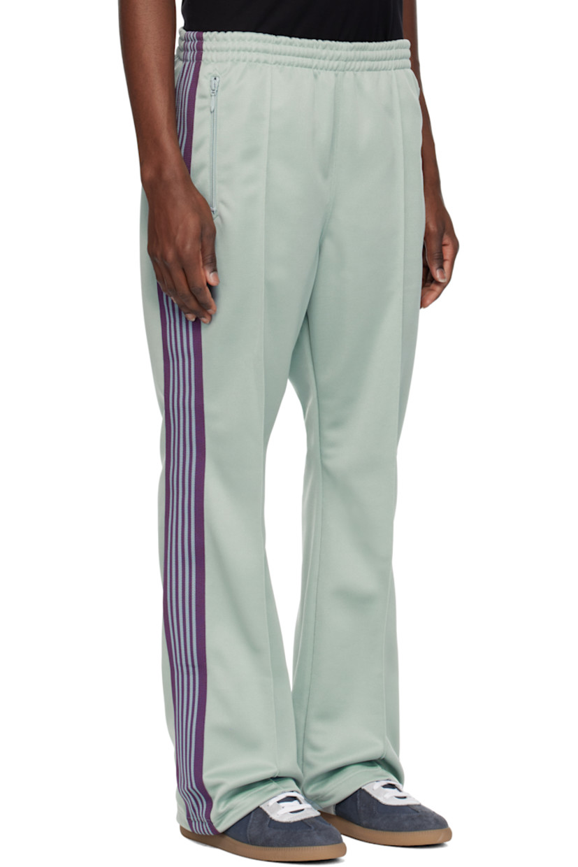 Bootcut polyester interlock jersey track pants.

· Concealed drawstring at elasticized waistband
· Three-pocket styling
· Pinched seams and embroidered logo graphic at front
· Striped knit trim at outseams

Supplier color: Sax