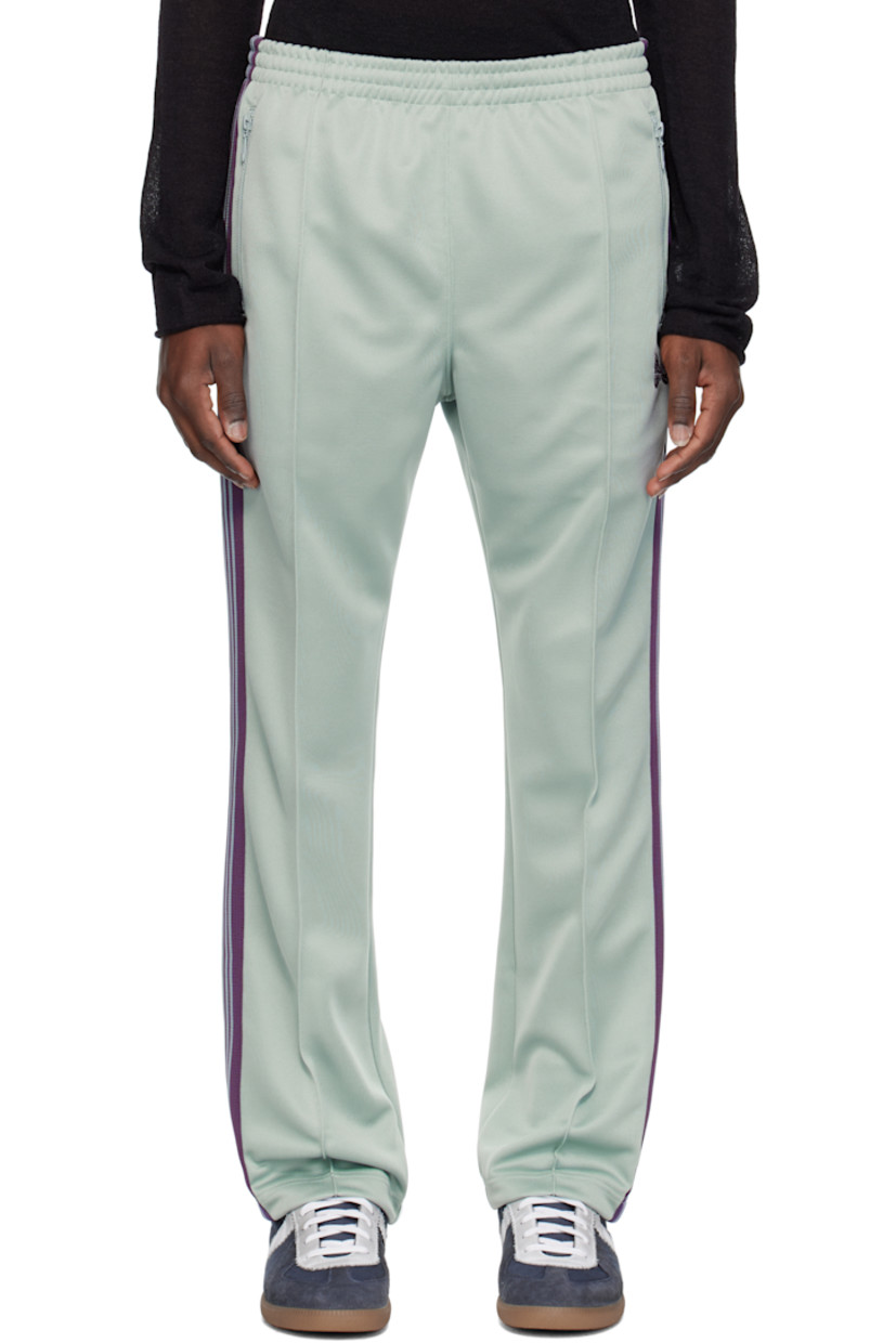 Polyester interlock jersey track pants.

· Concealed drawstring at elasticized waistband
· Three-pocket styling
· Pinched seams and embroidered logo graphic at front
· Striped knit trim at outseams

Supplier color: Sax
