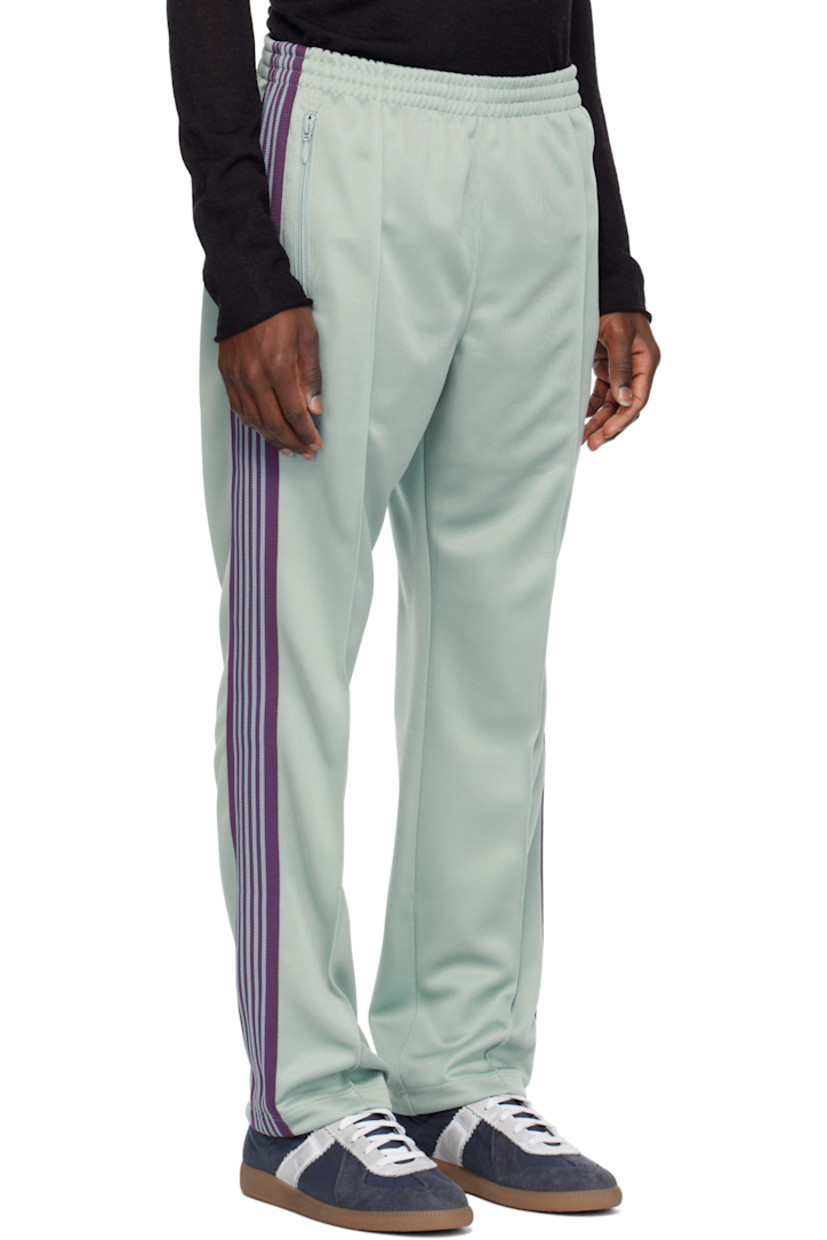 Polyester interlock jersey track pants.

· Concealed drawstring at elasticized waistband
· Three-pocket styling
· Pinched seams and embroidered logo graphic at front
· Striped knit trim at outseams

Supplier color: Sax