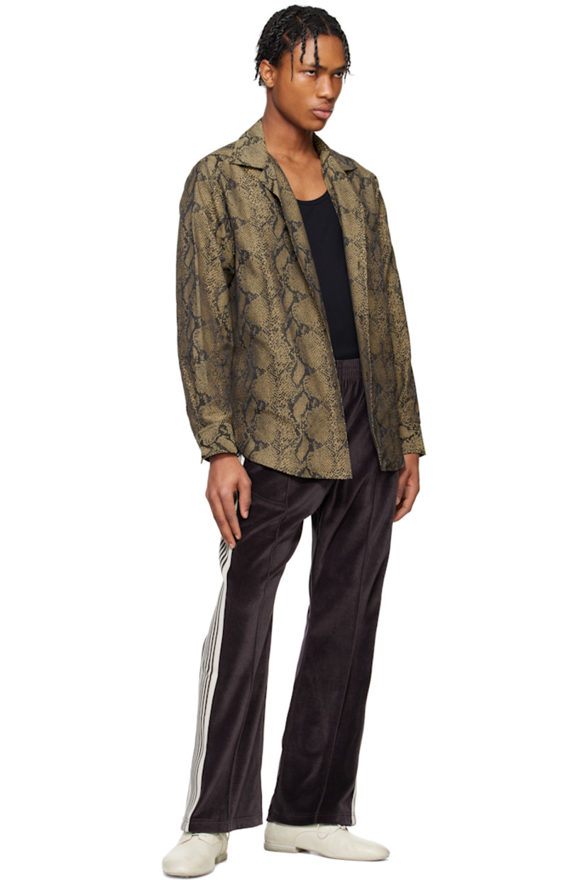 Polyester- and cotton-blend twill shirt. Jacquard snakeskin pattern throughout. 

· Spread collar
· Button closure
· Patch pocket
· Shirttail hem
· Pleat at buttoned barrel cuffs
· Box pleat at yoke

Supplier color: Brown