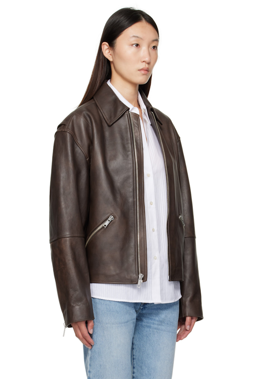 Saffiano leather jacket.

· Spread collar
· Zip closure
· Zip pockets at waist
· Dropped shoulders
· Zip vent at cuffs
· Logo patch at back collar
· Elasticized back hem
· Striped poplin lining

Part of the Calvin Klein Studio collection.

Supplier color: Dusty Umber