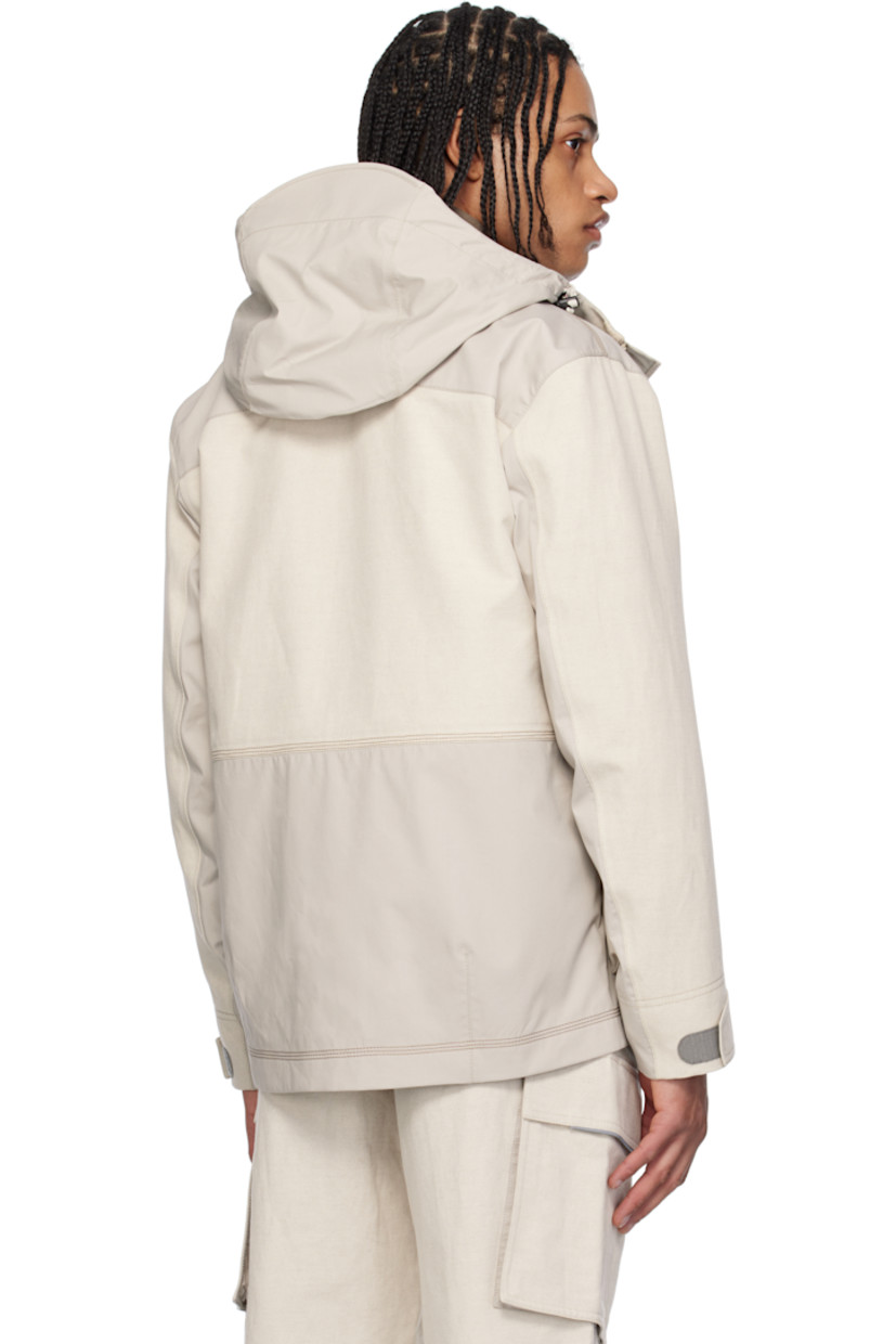 Lightweight cotton-blend canvas and broadcloth jacket.

· Windproof and waterproof 
· Paneled construction 
· Bungee-style drawstring at hood
· Concealed two-way zip closure
· Press-stud placket
· Lanyard clasp and grommets at chest
· Bellows and zip pockets  
· Suede logo patch at sleeve
· Adjustable velcro tab at cuffs
· Rubberized text bonded at cuff
· Partial mesh lining 

Part of the Day-Namic collection.

Supplier color: Soft beige